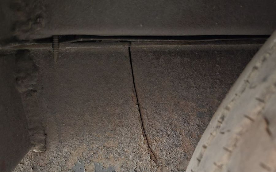 Crack in a trailer frame member next to the wheel