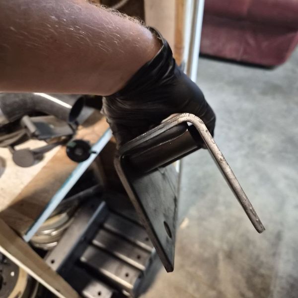 Bent steel bracket taken off a trailer