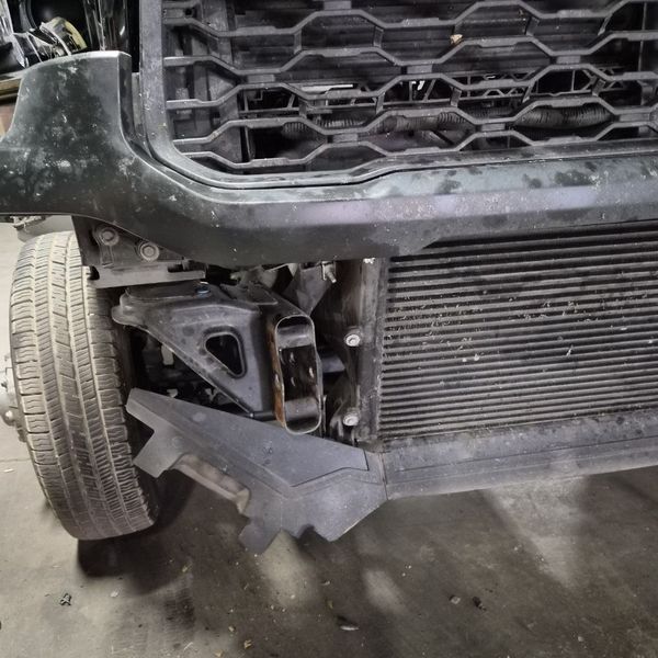 Pickup front end with a broken bumper after a hit